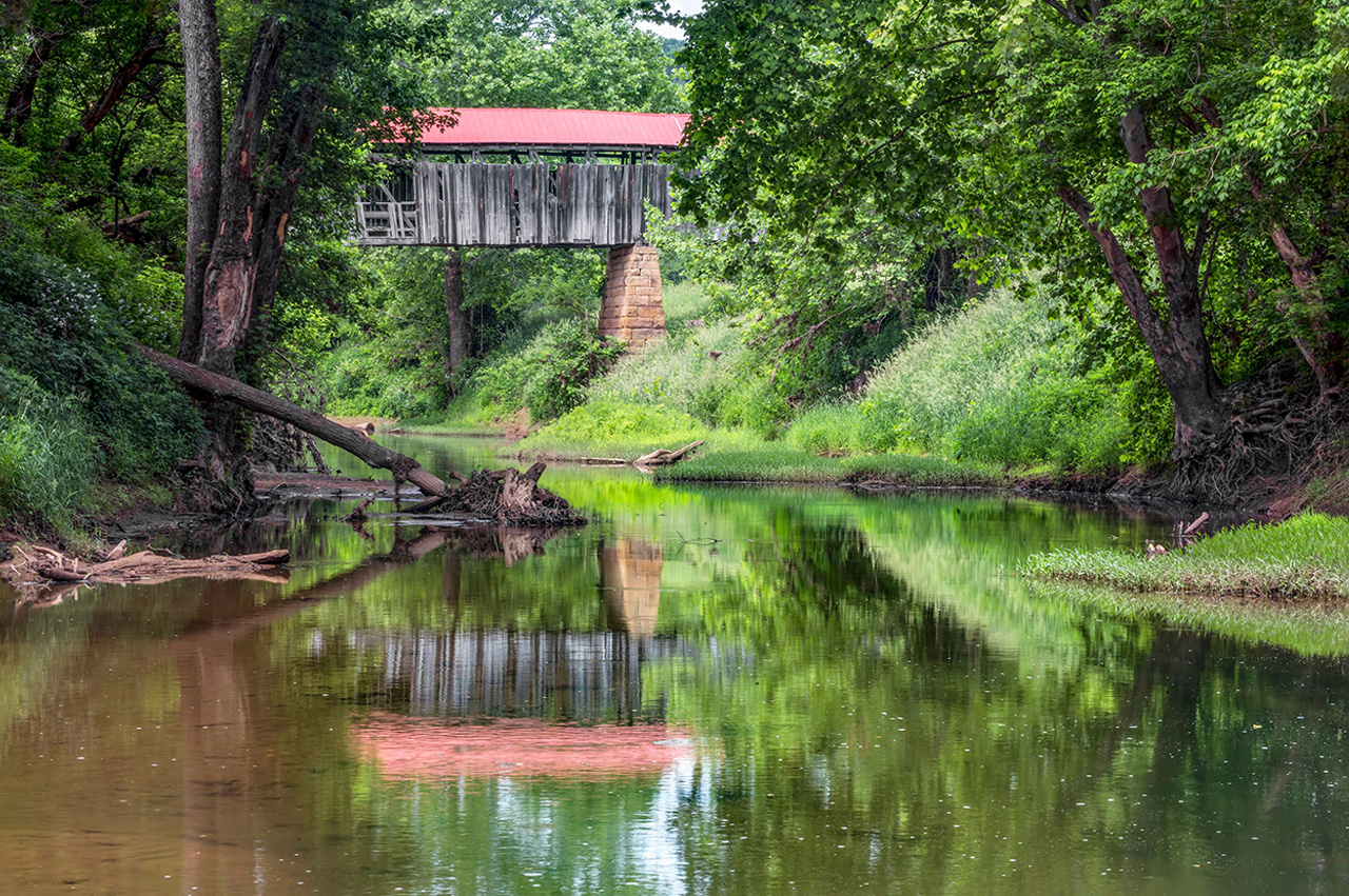 Covered bridge over a creek surrounded by trees in Ohio